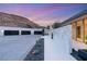 Modern home with a three car garage with desert landscaping and a serene setting against a mountain at 3 Horseshoe Rock Ct, Henderson, NV 89012
