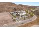 Modern hillside home with a three-car garage, manicured landscaping, and secure gated access at 3 Horseshoe Rock Ct, Henderson, NV 89012