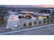 Contemporary home with an attached garage, fire feature, pristine desert landscaping, and city views at 3 Horseshoe Rock Ct, Henderson, NV 89012