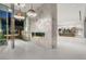 Elegant foyer showcases a striking marble accent wall, fireplace and decorative chandeliers, complemented by tile flooring at 3 Horseshoe Rock Ct, Henderson, NV 89012