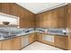 Close-up of the modern kitchen with light wood cabinets, granite counters, and stainless steel appliances at 3 Horseshoe Rock Ct, Henderson, NV 89012