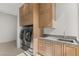 Well-equipped laundry room features modern washer/dryer, ample cabinet space, and a convenient sink at 3 Horseshoe Rock Ct, Henderson, NV 89012