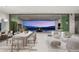 Open-concept living space with modern furnishings and a large sliding glass door to a patio with stunning city views at 3 Horseshoe Rock Ct, Henderson, NV 89012