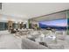 Open-concept living space with modern furnishings and a large sliding glass door to a patio with stunning city views at 3 Horseshoe Rock Ct, Henderson, NV 89012