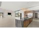 Bright, open-plan living area with fireplace, TV, and floor-to-ceiling glass doors at 3 Horseshoe Rock Ct, Henderson, NV 89012