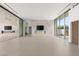 Open living space with large windows, modern fireplace, marble accents, and seamless transition between rooms at 3 Horseshoe Rock Ct, Henderson, NV 89012