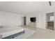 Open and bright primary bedroom with tv, tile floors, and en suite bath at 3 Horseshoe Rock Ct, Henderson, NV 89012