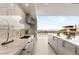 Sleek outdoor kitchen with marble countertops, stainless steel appliances, and stunning city views at 3 Horseshoe Rock Ct, Henderson, NV 89012