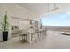 A modern outdoor kitchen with a marble counter, a built-in grill, and views of the city skyline enhances the luxury outdoor living at 3 Horseshoe Rock Ct, Henderson, NV 89012