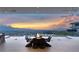 Panoramic view of mountains and cityscape seen from luxurious outdoor living space with fire pit table at 3 Horseshoe Rock Ct, Henderson, NV 89012