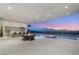 Entertainer's dream patio with outdoor kitchen, infinity pool, and stunning city views at dusk at 3 Horseshoe Rock Ct, Henderson, NV 89012