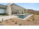 The outdoor space has a large pool with water features, an outdoor kitchen, and views, perfect for outdoor living and entertaining at 3 Horseshoe Rock Ct, Henderson, NV 89012