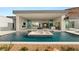 The outdoor space includes a pool with water features, an outdoor kitchen, and an inviting transition to the home's interior at 3 Horseshoe Rock Ct, Henderson, NV 89012