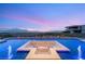Beautiful infinity pool with a built-in fire pit lounge and panoramic city views at 3 Horseshoe Rock Ct, Henderson, NV 89012