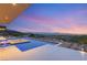 Stunning infinity pool overlooking the city and mountain landscape with an outdoor fire pit lounge at 3 Horseshoe Rock Ct, Henderson, NV 89012