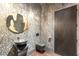 Modern powder room with unique sink, dark fixtures, and textured wallpaper for a stylish touch at 3 Horseshoe Rock Ct, Henderson, NV 89012