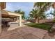 Beautiful backyard featuring a covered patio with lush lawn and vibrant landscaping at 3005 Dotted Wren Ave, North Las Vegas, NV 89084