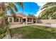 Expansive backyard with patio, lush lawn, and mature palm trees creating a relaxing oasis at 3005 Dotted Wren Ave, North Las Vegas, NV 89084