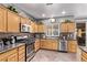 Well-lit kitchen featuring granite countertops, stainless steel appliances, and wood cabinetry at 3005 Dotted Wren Ave, North Las Vegas, NV 89084