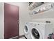 Convenient laundry room with modern washer and dryer, plus ample storage shelves at 3005 Dotted Wren Ave, North Las Vegas, NV 89084
