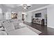Open concept living room with dark wood floors and a comfortable gray sectional sofa at 3005 Dotted Wren Ave, North Las Vegas, NV 89084