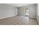 Spacious living room featuring wood-look flooring and sliding glass door access to outdoor space at 3233 Walker River St, North Las Vegas, NV 89032