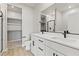 Modern bathroom featuring double sinks, quartz countertops, and a walk-in shower with sleek, black fixtures at 3237 Walker River St, North Las Vegas, NV 89032