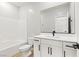 Clean bathroom with white cabinets, marble countertops, and a shower-tub combo, ready for relaxation at 3237 Walker River St, North Las Vegas, NV 89032