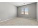 Cozy bedroom with neutral carpet, a large window letting in natural light, and a fresh coat of paint at 3237 Walker River St, North Las Vegas, NV 89032