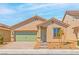 Charming single-story home featuring a well-maintained front yard and a two-car garage in a residential neighborhood at 3237 Walker River St, North Las Vegas, NV 89032