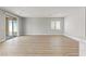 Bright, open-concept living room with wood-look flooring and sliding glass doors to the outdoor patio at 3237 Walker River St, North Las Vegas, NV 89032