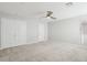 Spacious bedroom featuring plush carpeting, a ceiling fan, and ample natural light from the window at 354 Spotted Dove St, Las Vegas, NV 89138