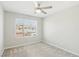 Bright bedroom featuring carpet, a ceiling fan, and a window offering neighborhood views at 354 Spotted Dove St, Las Vegas, NV 89138