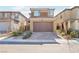 Two-story home featuring a brick paved driveway, neutral color palette, and well-maintained landscaping at 354 Spotted Dove St, Las Vegas, NV 89138