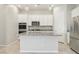 Modern kitchen with stainless steel appliances and a center island for food preparation at 354 Spotted Dove St, Las Vegas, NV 89138
