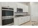 Gourmet kitchen featuring granite counters, stainless steel appliances, and white cabinets at 354 Spotted Dove St, Las Vegas, NV 89138