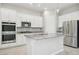 Modern kitchen featuring white cabinetry, stainless steel appliances, and a spacious granite countertop island at 354 Spotted Dove St, Las Vegas, NV 89138