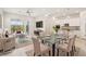 Bright, open-concept living area with modern furniture, a dining table, and a seamless flow to the kitchen at 354 Spotted Dove St, Las Vegas, NV 89138