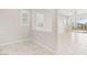 Bright living room showcasing large tile flooring, modern window shutters, and seamless access to the outdoor patio at 354 Spotted Dove St, Las Vegas, NV 89138