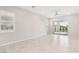 Spacious living room featuring large tile flooring, modern shutters, and direct access to outdoor living space at 354 Spotted Dove St, Las Vegas, NV 89138