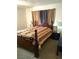 A cozy bedroom featuring a dark wood bed frame, matching nightstands, and soft carpet flooring at 3550 Bay Sands Dr # 3001, Laughlin, NV 89029