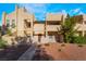 Tan two story townhome featuring a well maintained landscape and inviting entrance, perfect for a new Gathering at 3937 S Torrey Pines Dr, Las Vegas, NV 89103