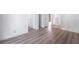Hallway with modern laminate flooring and white doors leading to various rooms at 3937 S Torrey Pines Dr, Las Vegas, NV 89103