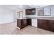 Bright kitchen featuring granite countertops, dark brown cabinetry and a breakfast bar at 3937 S Torrey Pines Dr, Las Vegas, NV 89103