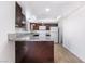 Compact kitchen features granite countertops, white appliances, wood cabinetry, and tile flooring providing a modern feel at 3937 S Torrey Pines Dr, Las Vegas, NV 89103
