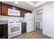 Bright kitchen boasts white appliances and leads to in-unit laundry room with washer and dryer at 3937 S Torrey Pines Dr, Las Vegas, NV 89103