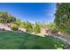 Lush backyard featuring healthy lawn, privacy wall, and landscaping at 4012 Owlshead Mountain St, Las Vegas, NV 89129