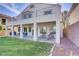 A large backyard offers a covered patio and green space, ideal for outdoor living and entertaining at 4012 Owlshead Mountain St, Las Vegas, NV 89129