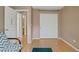 Spacious bedroom with wood laminate flooring, double doors and light-colored walls, providing a versatile space at 4012 Owlshead Mountain St, Las Vegas, NV 89129