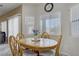 Inviting breakfast nook with wood table, bright windows, and a view of the outdoors at 4012 Owlshead Mountain St, Las Vegas, NV 89129